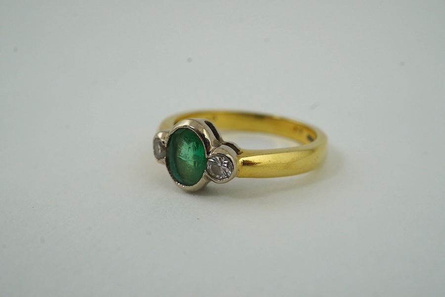 A modern 18ct gold, emerald and diamond set three stone ring, size N, gross weight 4.4 grams. Condition - fair